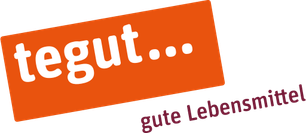 Das Logo von tegut... zeigt den Schriftzug in Weiß auf einem orangefarbenen Hintergrund, begleitet von einem Slogan.